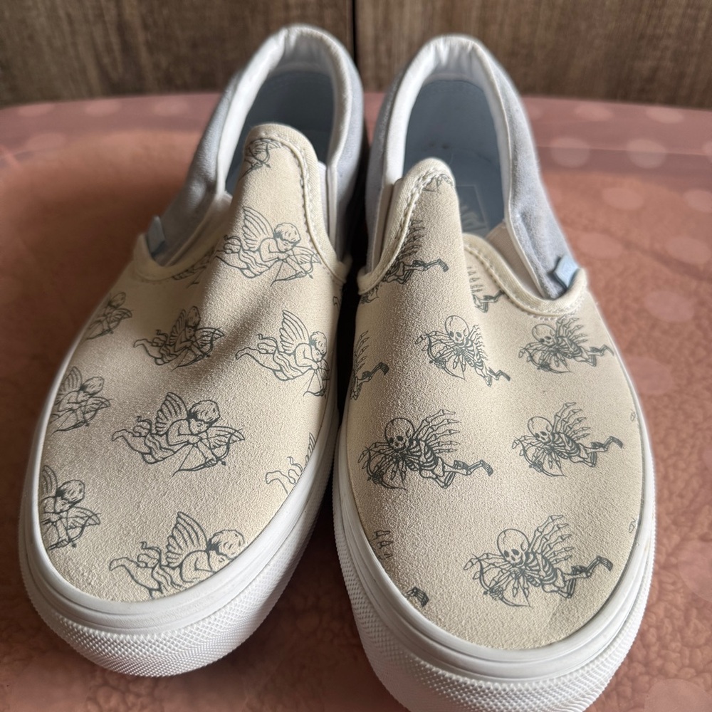 Vans Slip-On Sneakers in Cream and Dusty Blue with Angel & Skeleton Print